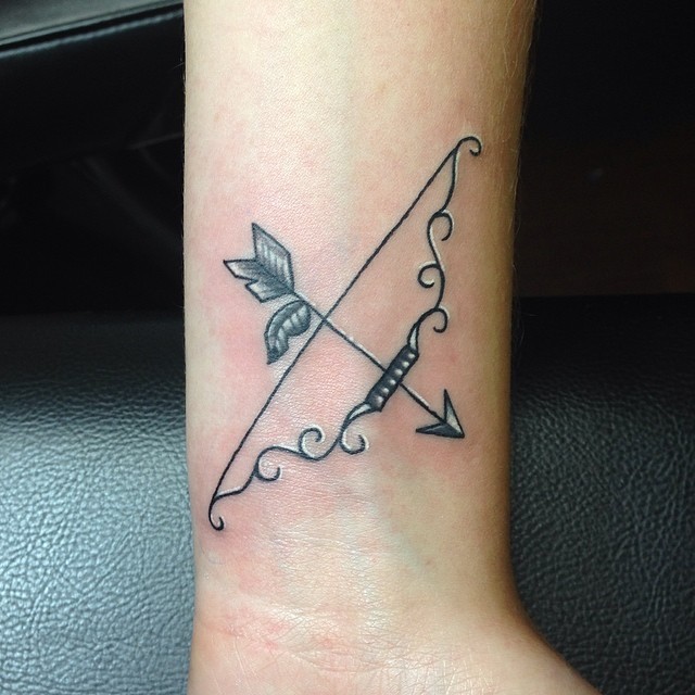 downward pointing bow and arrow tattoo