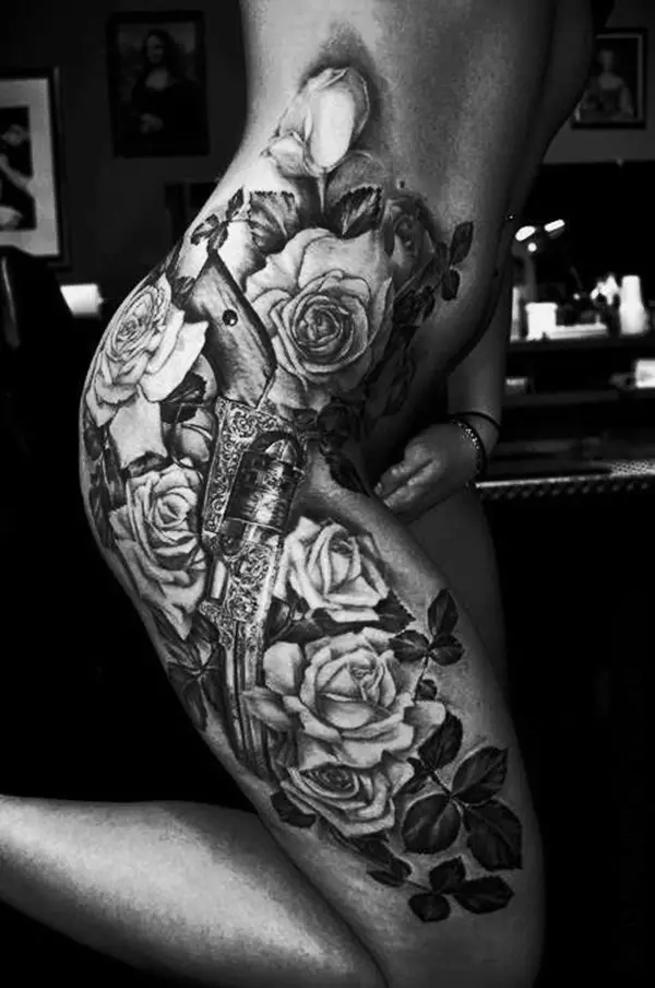 rose with gun thigh tattoos for women