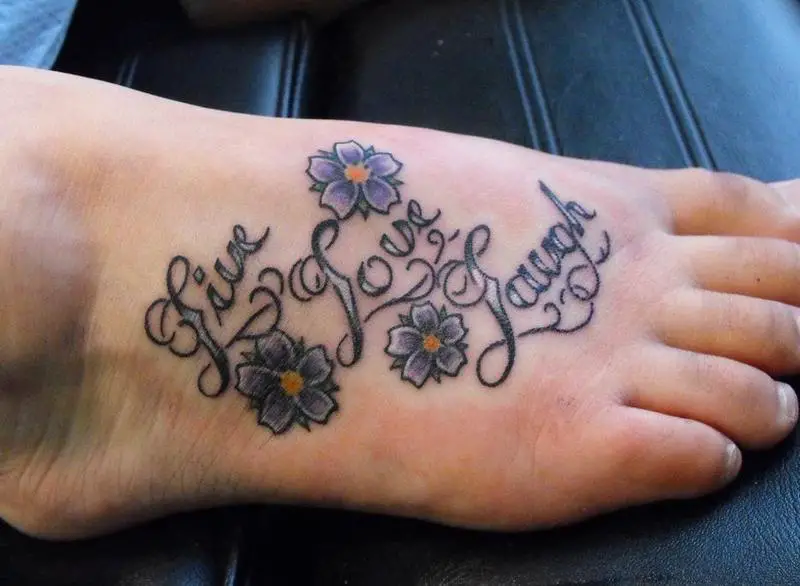 tattoo With purple flowers on the feet
