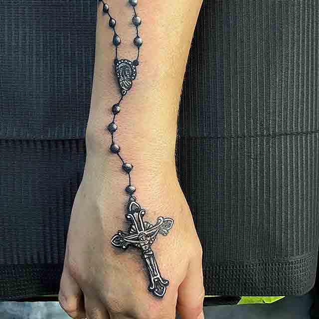 Rosary tattoo located on the wrist