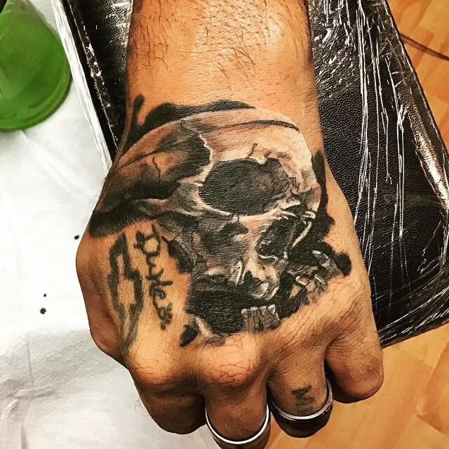 skull hand tattoos