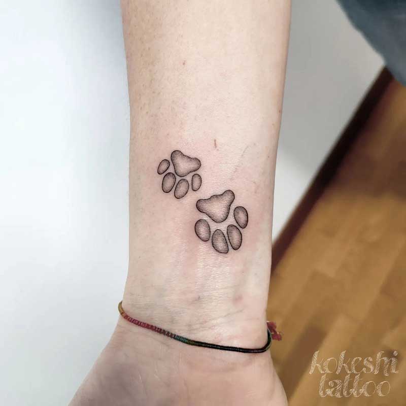 cat-paw-inside-dog-paw-tattoo--3