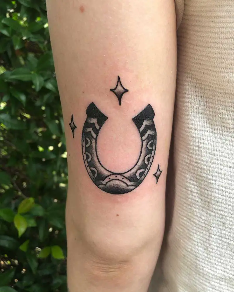 Minimalistic style horseshoe tattoo located on the