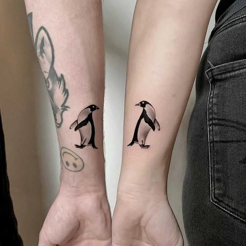 Black And Grey Ink Penguin Tattoos Design