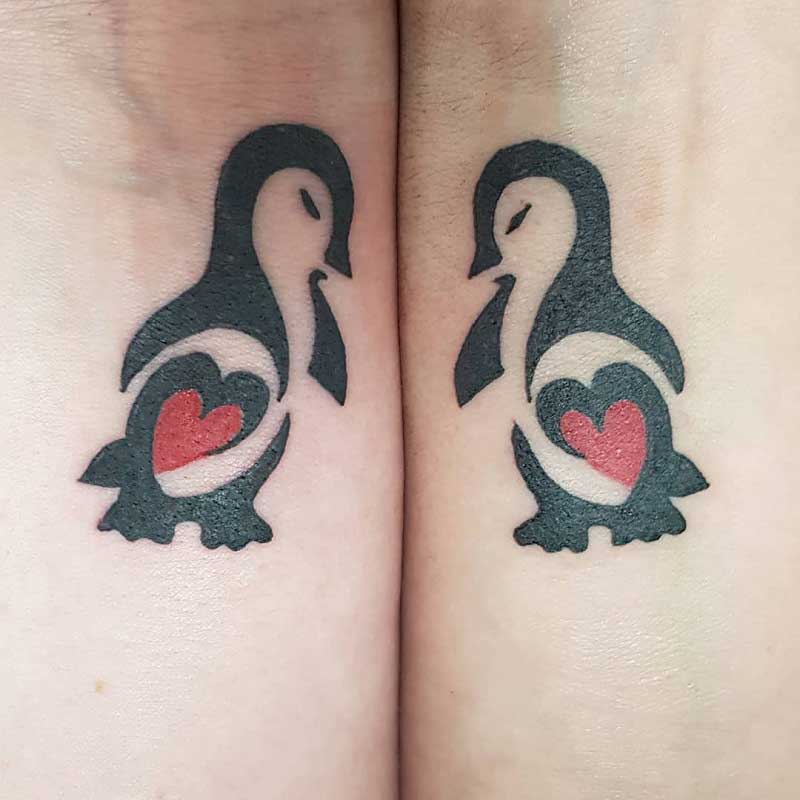 tribal penguin heart tattoo