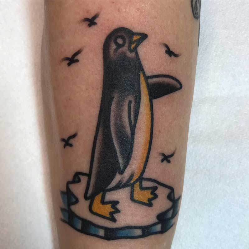 Single needle penguin tattoo on the right inner