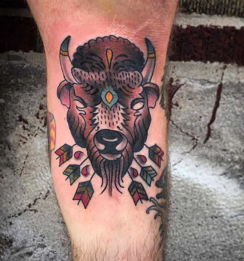 Man showing off fully colored buffalo knee tattoo  ClipStock